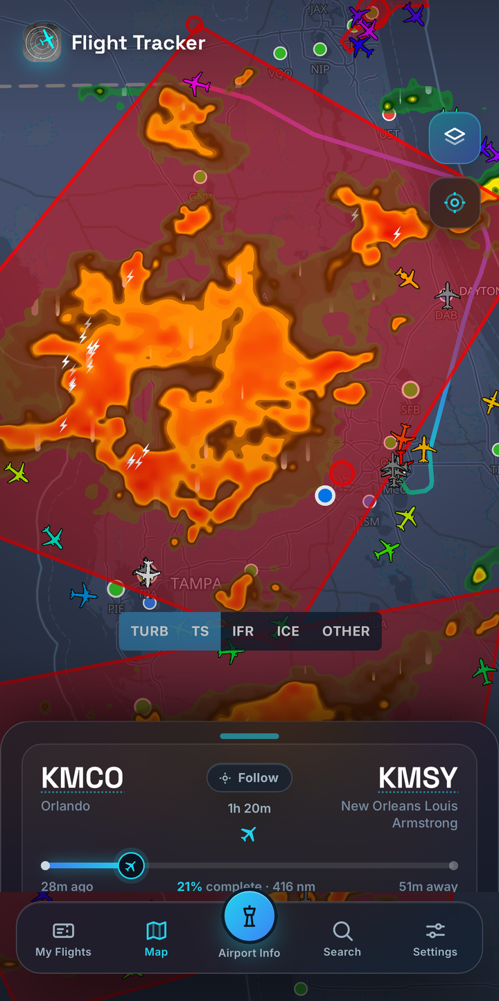 Flight Tracker showing live aircraft over Florida with a convective storm cell, lightning strikes, and red hazard areas on the same map, with turbulence and thunderstorm layers toggled on